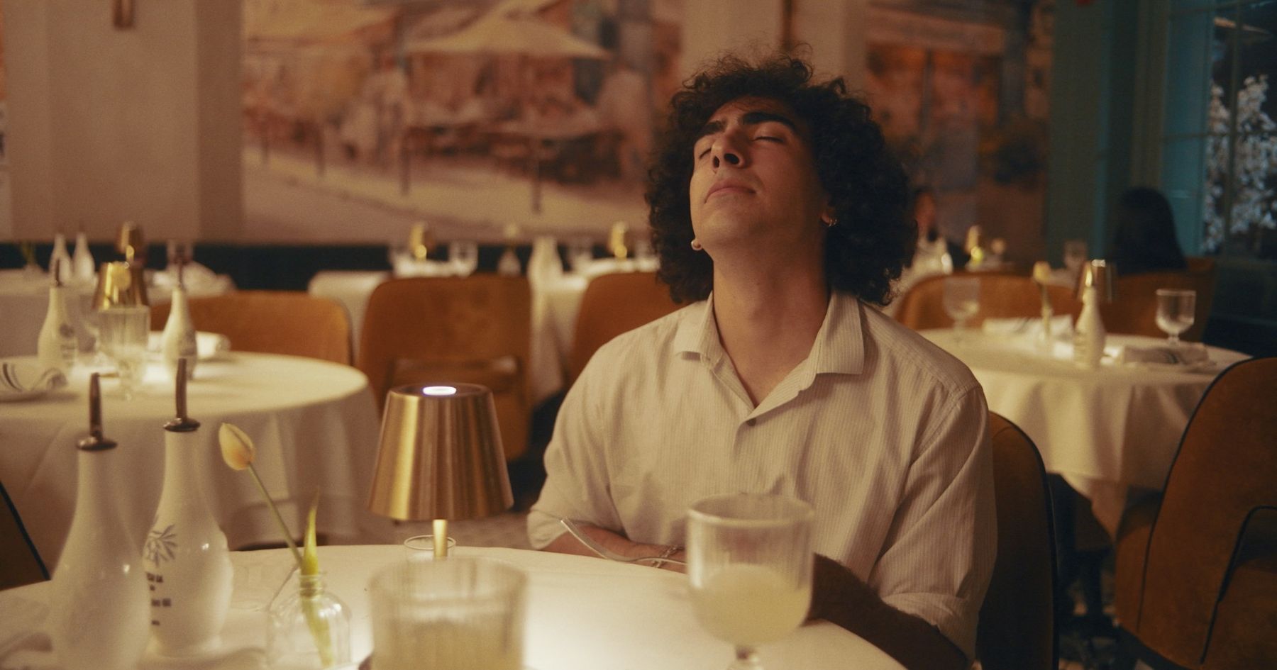 milo at the table, head tipped back