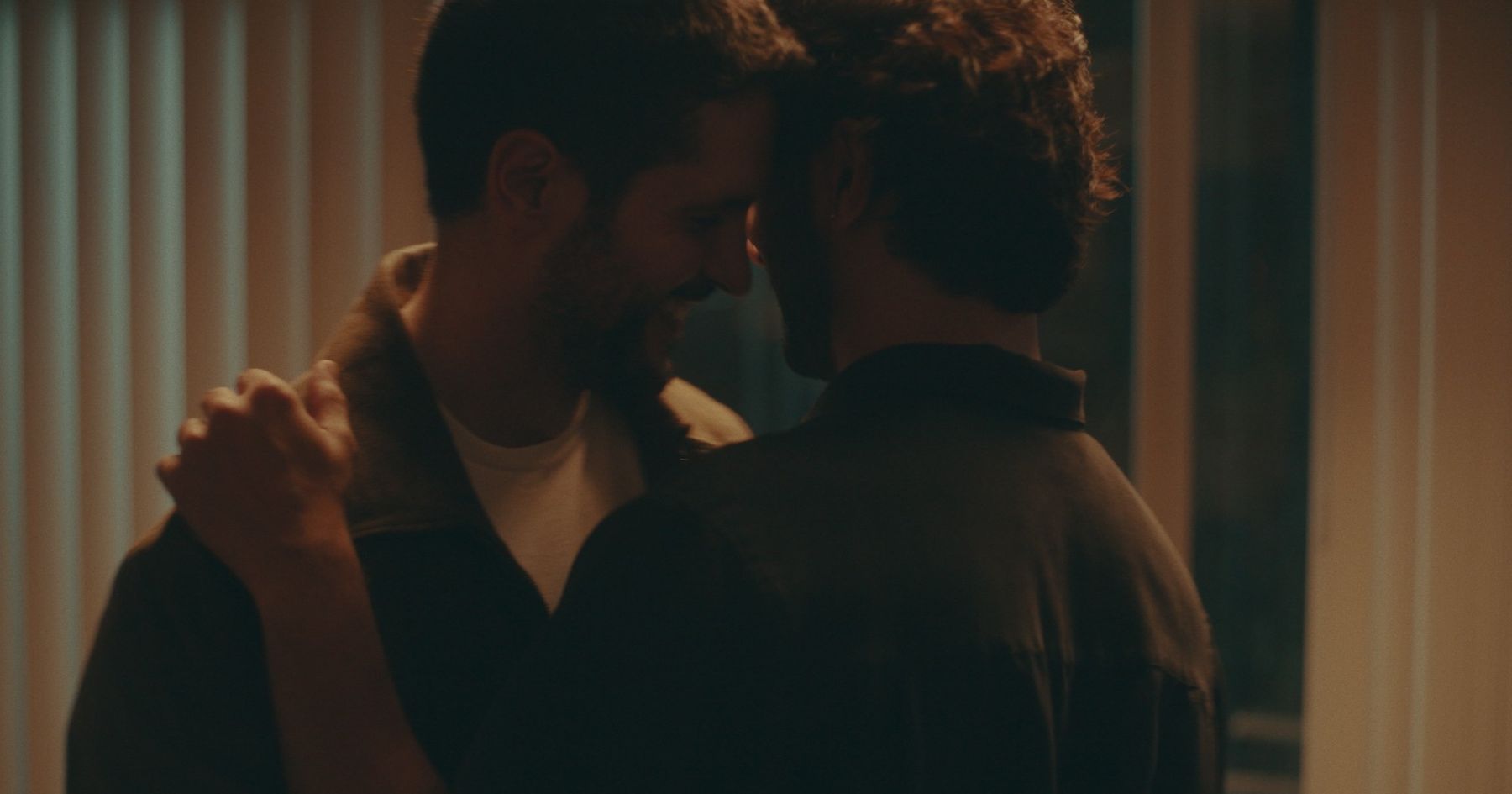 Two men embracing in silhouette